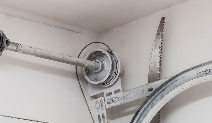 A metal torsion spring and cable drum assembly