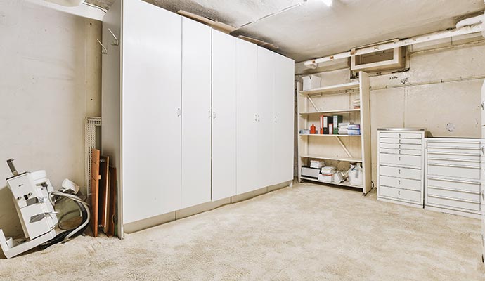 Clean and organized garage room with custom cabinets
