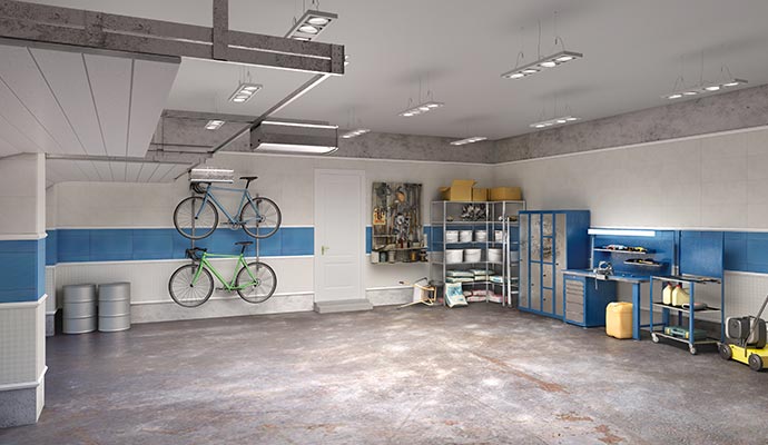 Organized garage with bike racks, blue cabinets and wall-mounted shelves