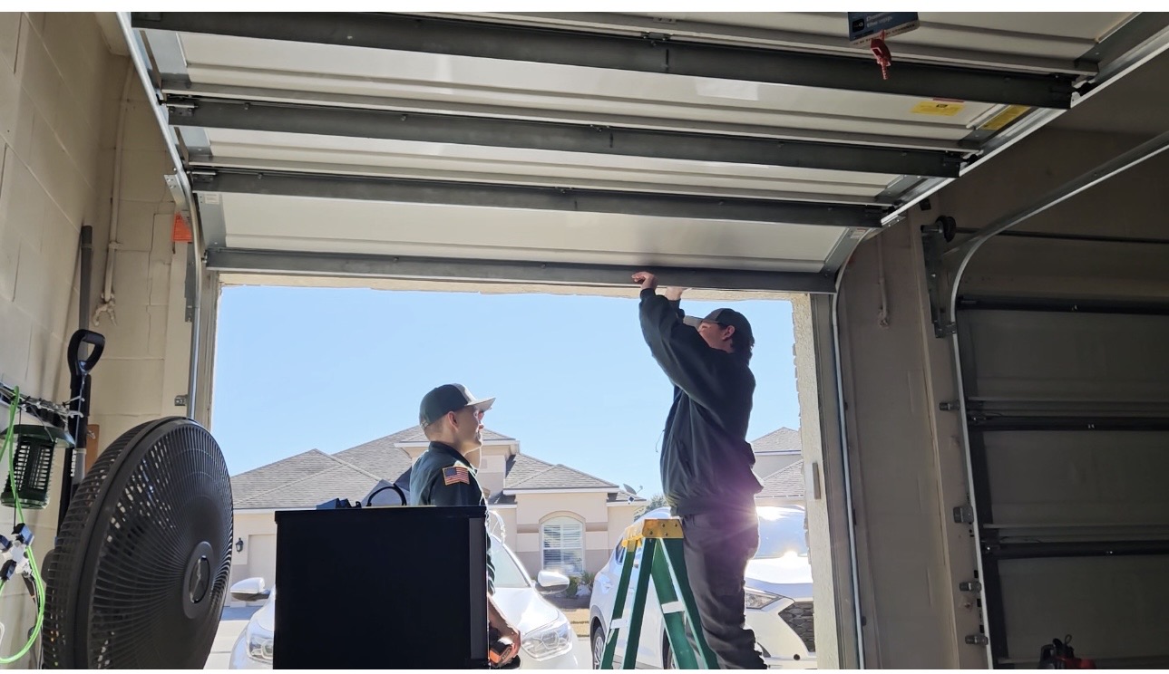 Deklin and Adam working on the garage dr